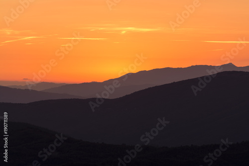 layers of mountains at sunset © photonik87