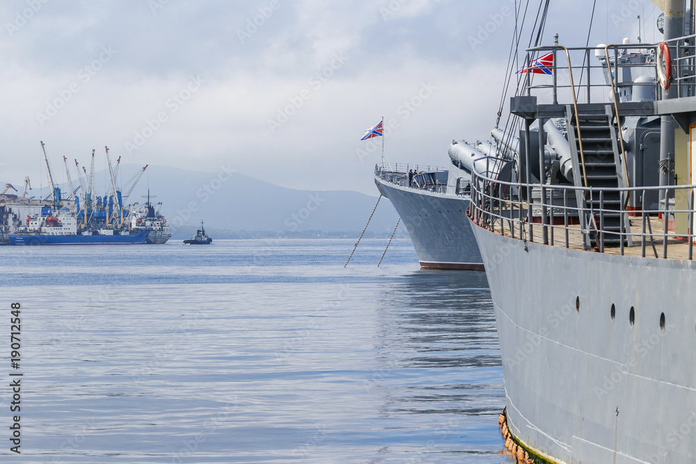 Naklejka premium Vladivostok, Russia, 2017: Merchant and warships on the roadstead in the Golden Horn Bay in Vladivostok. Seaport Vladivostok