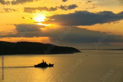 Vladivostok, Russia, 2017: Merchant and warships on the roadstead in the Golden Horn Bay in Vladivostok. Seaport Vladivostok © alexhitrov