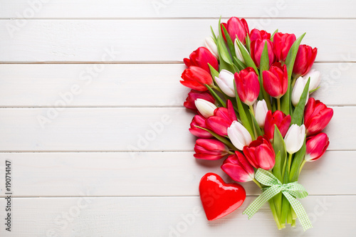Springt time. Red tulip bouquet on the white wooden background.