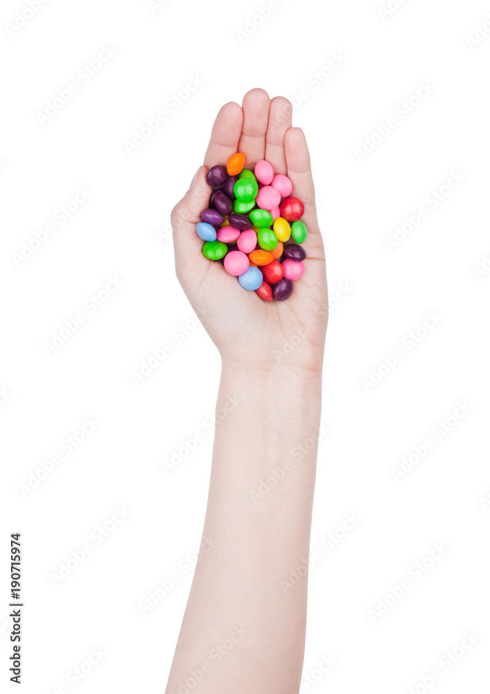 Female hand hold round color chocolate candies Female hand hold round color chocolate candies