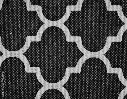 background texture of black geometric lattice fabric with weave visible