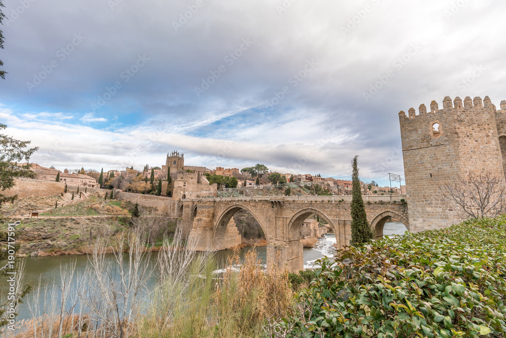 View of Toledo walls, Monastery of San Juan de los Reyes and Puente de San Martin Bridge over the (Tajo) Tagus River