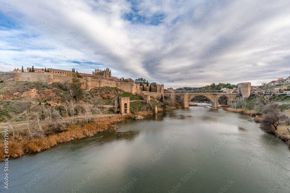 View of Toledo walls, Monastery of San Juan de los Reyes and Puente de San Martin Bridge over the (Tajo) Tagus River