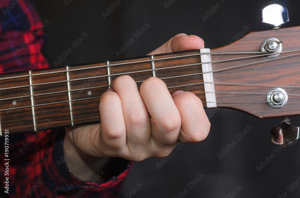  Musician Playing accord Am on acoustic guitar, close up