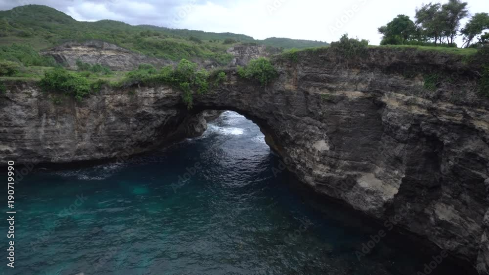 Stone arch over the ocean. Broken beach, Nusa Penida, Indonesia