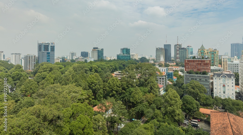 Saigon, Ho Chi Minh, Vietnam, Asia, 29 January 2018- Skyline view of the capital city Ho Chi Minh Saigon by day and lush green trees in local parks.