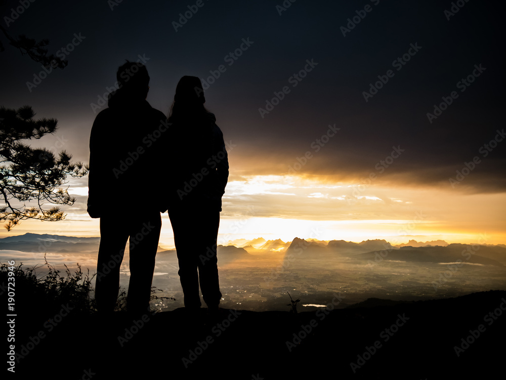 silhouette couple standing on moutains with sunrise nature landscape background