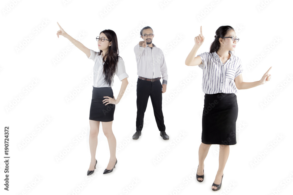 Business team touching something on studio Business team touching something on studio