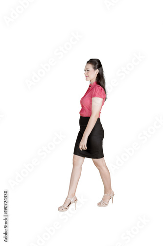 Caucasian businesswoman walking in the studio