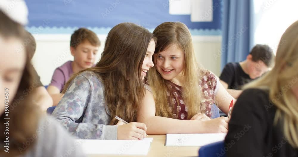 4k, Talkative school girls whispering to each other during a class. 4k, Talkative school girls whispering to each other during a class.