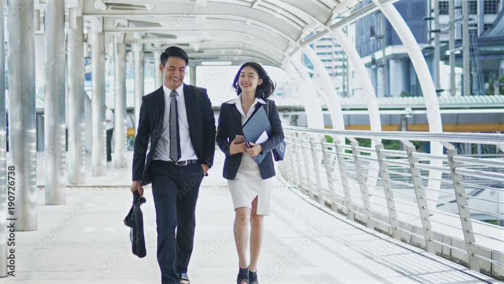 Young man and pretty woman checking map with a smartphone Young man and pretty woman checking map with a smartphone