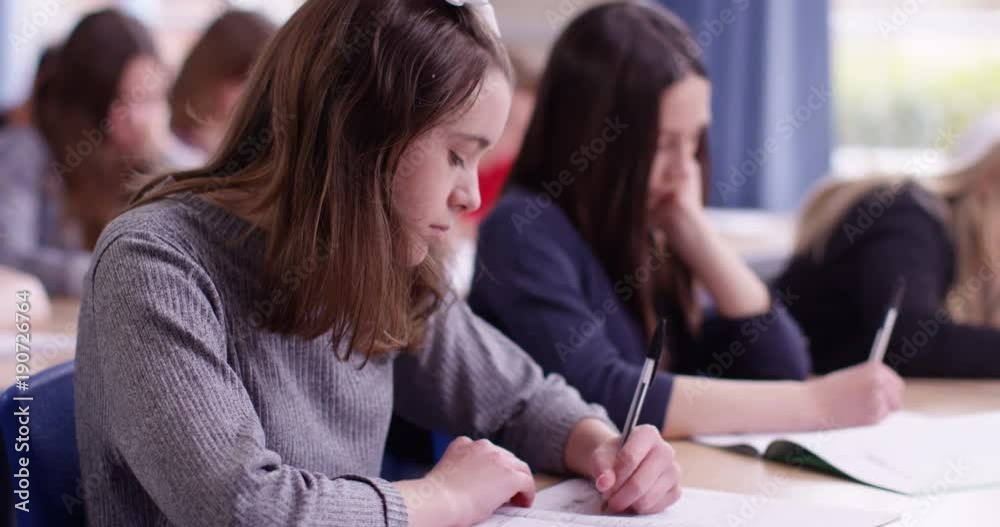 4k, A young girl in a classroom concentrating on her test 4k, A young girl in a classroom concentrating on her test