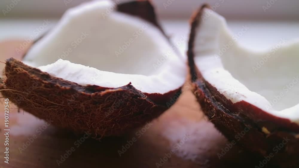 Fresh coconut with flowing coconut milk on a bamboo board. Fresh coconut with flowing coconut milk on a bamboo board.