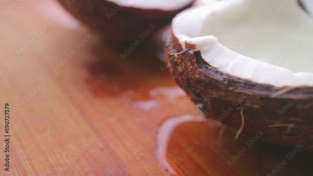 Fresh coconut with flowing coconut milk on a bamboo board. Fresh coconut with flowing coconut milk on a bamboo board.