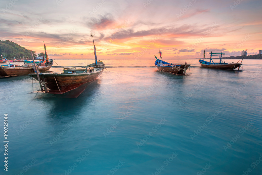 beautiful panorama landscape of silhouette fisherman boat floating in sea at the beach at dusk and reflection on sea. boat in the sea in evening when sunset