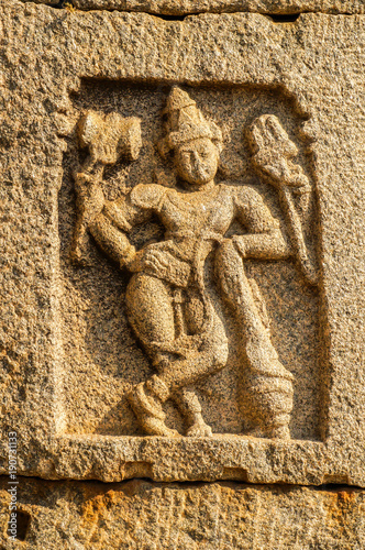 Carved stone Shiva on the old temple in Hampi, India. photo