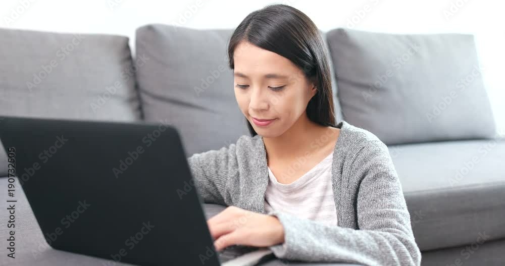 Woman working on laptop computer at home