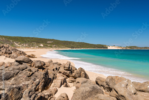 Desserted sandy beach with clear blue waters in summer