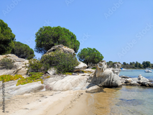 Beach with sand next to rocks on the island Diaporos of Chalkidiki Macedonia Greece