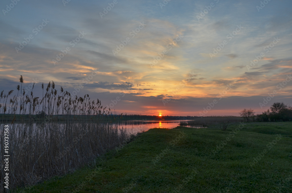 sunrise on green banks of Mechetka river in spring stanitsa Mechetinskaya, Rostov region, Russia