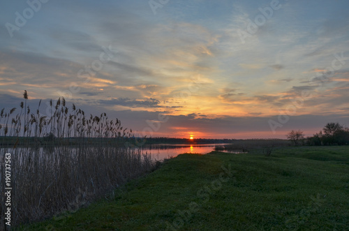 sunrise on green banks of Mechetka river in spring stanitsa Mechetinskaya, Rostov region, Russia