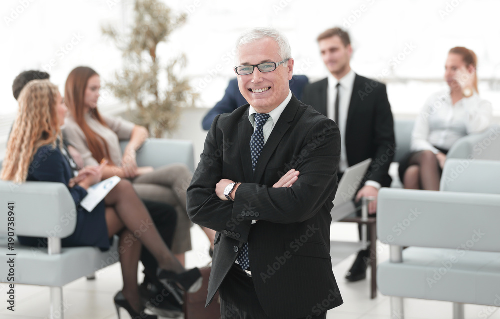 smiling senior businessman on the background of business team smiling senior businessman on the background of business team