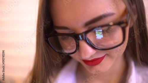 Wallpaper Mural Woman wearing glasses and using mobile phone, the reflection of the display of the mobile phone in glasses. 4 k. Close-up shot of woman eyes in glasses reflecting a mobile phone. sms. Torontodigital.ca