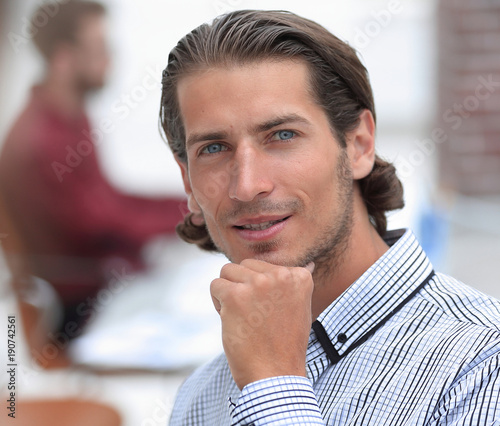 confident businessman on background of office.