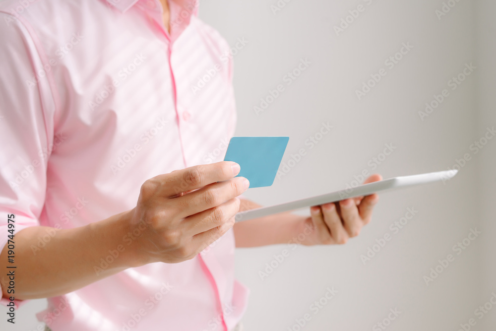 Hands holding credit card and using digital tablet. Online shopping concept Hands holding credit card and using digital tablet. Online shopping concept