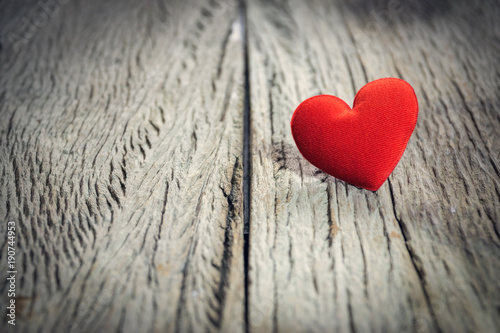 Red heart on wooden floor with copy space for text  used in love concept on Valentine s Day.