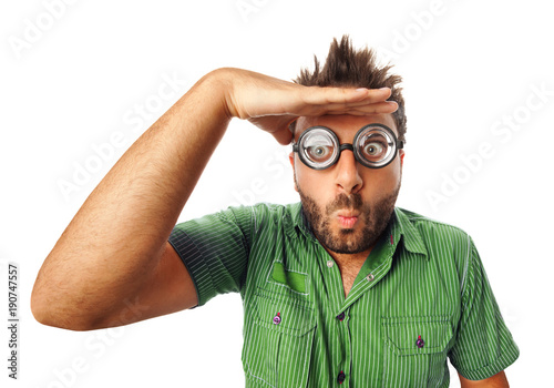 Man with funny expression and thick glasses looking far away.