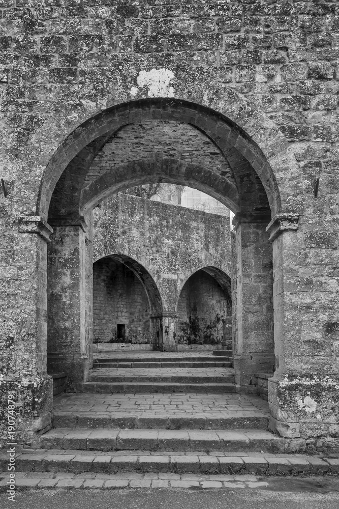 Black and white view of Porta and Fonti di Docciola, walls of Volterra, Pisa, Tuscany, Italy