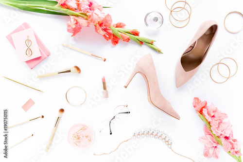 Beauty blog fashion concept. Female pink styled accessories: brushes, glasses, cosmetics, jewelry, shoes on white background. Flat lay, top view trendy feminine background. 
