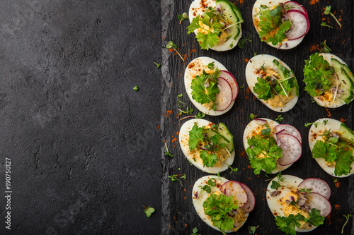 stuffed eggs on black slate board