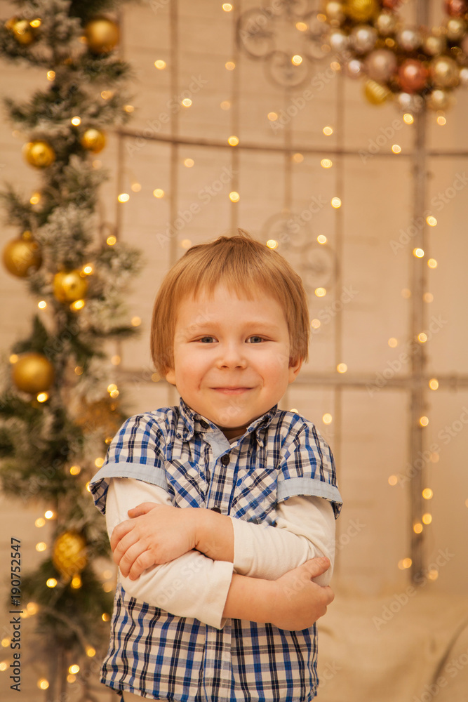 A little boy in the background of beautiful lights. Stylish guy A little boy in the background of beautiful lights. Stylish guy