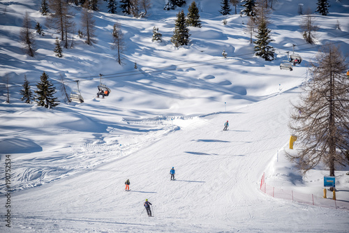 Skiers on a ski track on a beautiful sunny day in the Alps