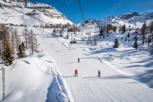 Skiers on a ski track on a beautiful sunny day in the Alps