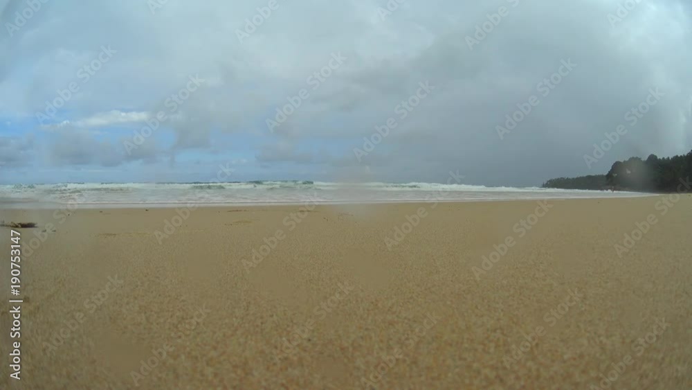 Girl running towards to camera on beach, young woman runner on a sand beach, stormy sea and sky Girl running towards to camera on beach, young woman runner on a sand beach, stormy sea and sky