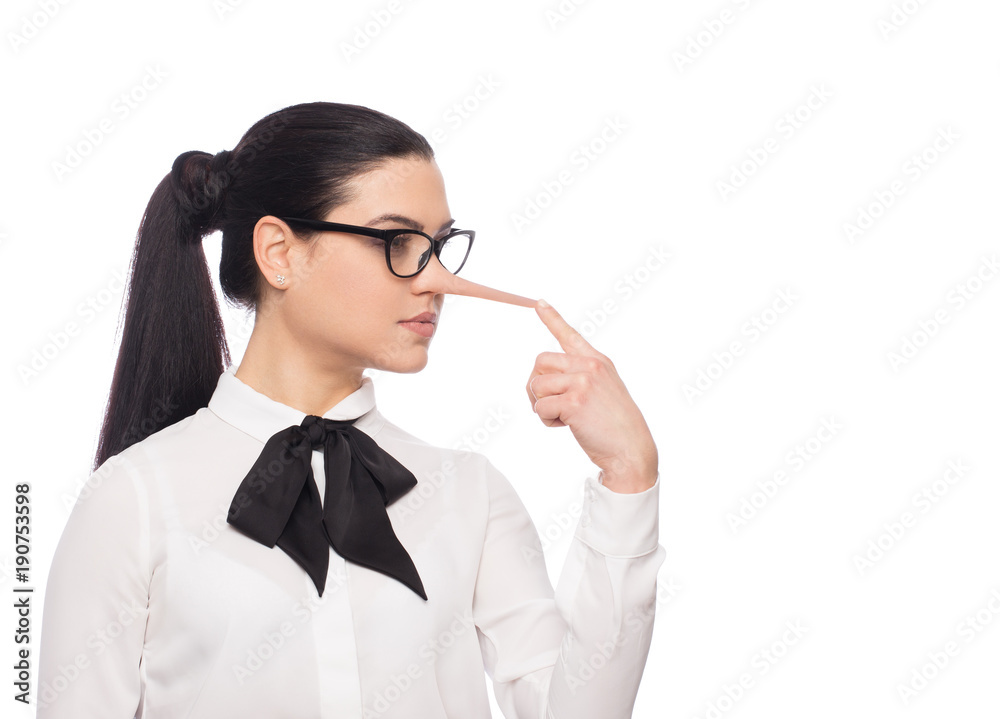 Liar caucasian brunette woman in eyeglasses touching enlarged nose by finger isolated Liar caucasian brunette woman in eyeglasses touching enlarged nose by finger isolated