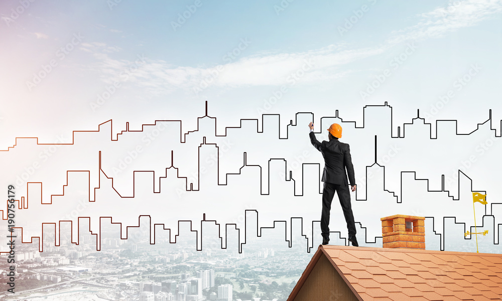Man architect draw silhouette of modern city on blue sky. Mixed media Man architect draw silhouette of modern city on blue sky. Mixed media