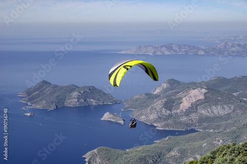 paraglider fly over the coastline from the top of Babadag, Turkey