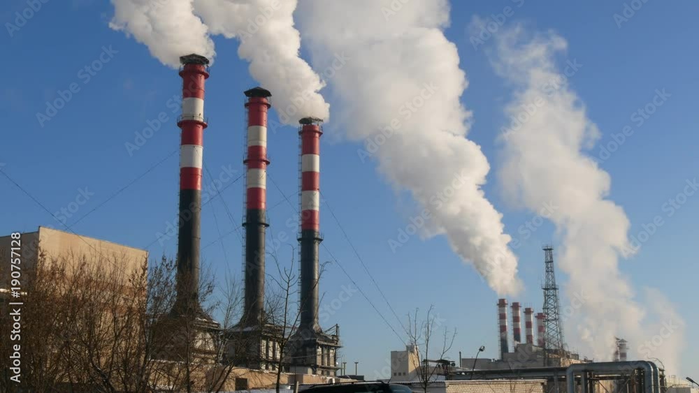 Air pollution. Factory plant smoke stack over blue sky background. Energy generation and air environment pollution industrial scene. Air pollution. Factory plant smoke stack over blue sky background. Energy generation and air environment pollution industrial scene.