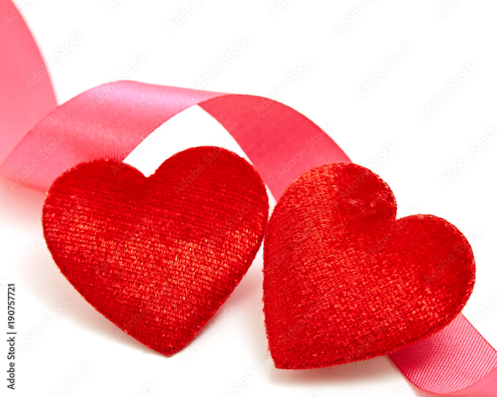 Two red hearts with pink ribbon