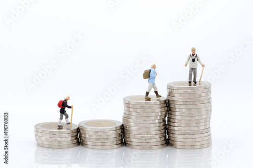 Miniature people: Old people standing on top of stack coins . Image use for background retirement planning, Life insurance concept.