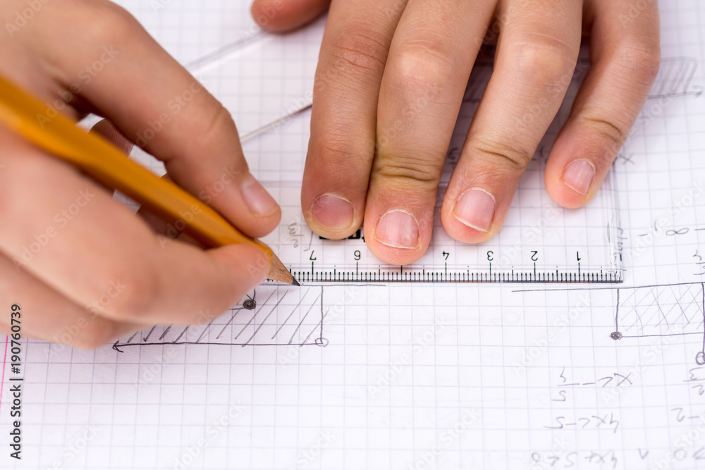 Schoolboy Hands with Ruler Drawing on White Paper. Mathematics Concept. Schoolboy Hands with Ruler Drawing on White Paper. Mathematics Concept.