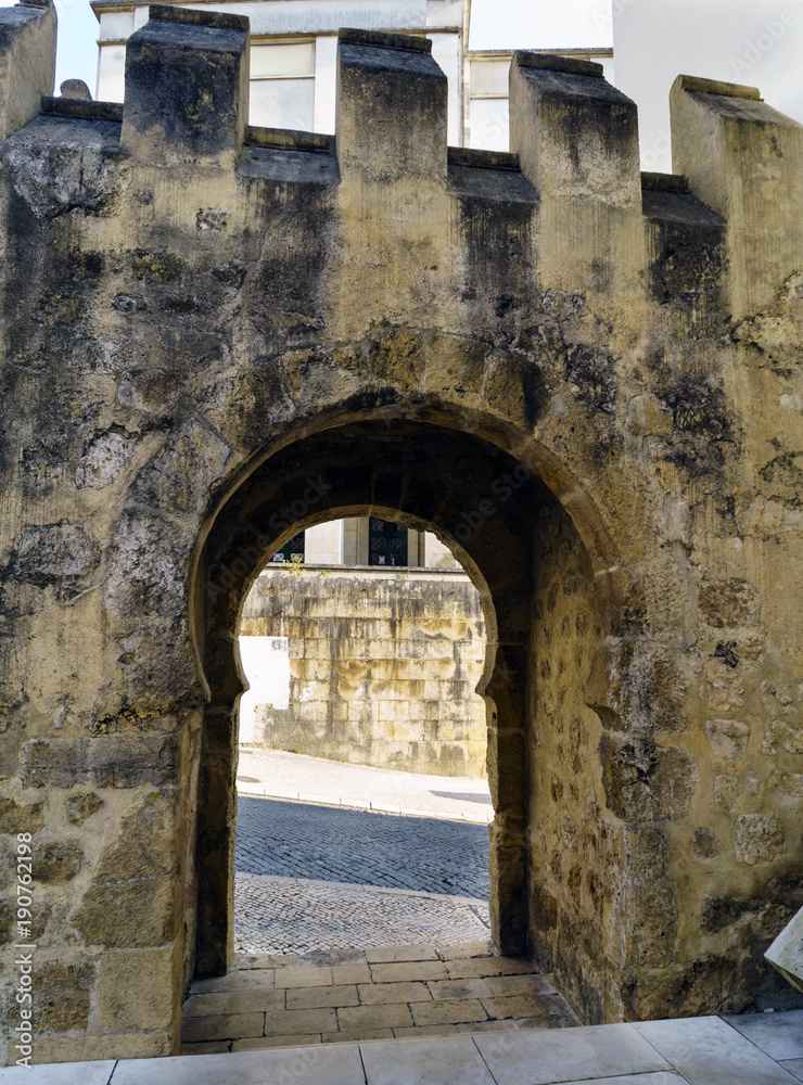 Detail of the remains of a medieval stone gate located next to the facade of the National Museum called de Machado Castro in Coimbra, Portugal