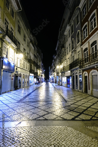 Coimbra, Portugal, August 13, 2018: Night view of the main shopping street in the old center of the city with people walking and very well lit