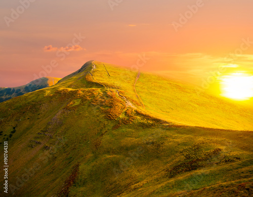 green mountain ridge at the sunset