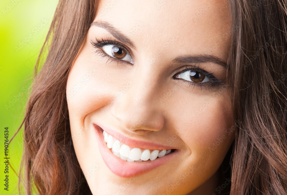 Fototapeta premium Young happy smiling woman, outdoors